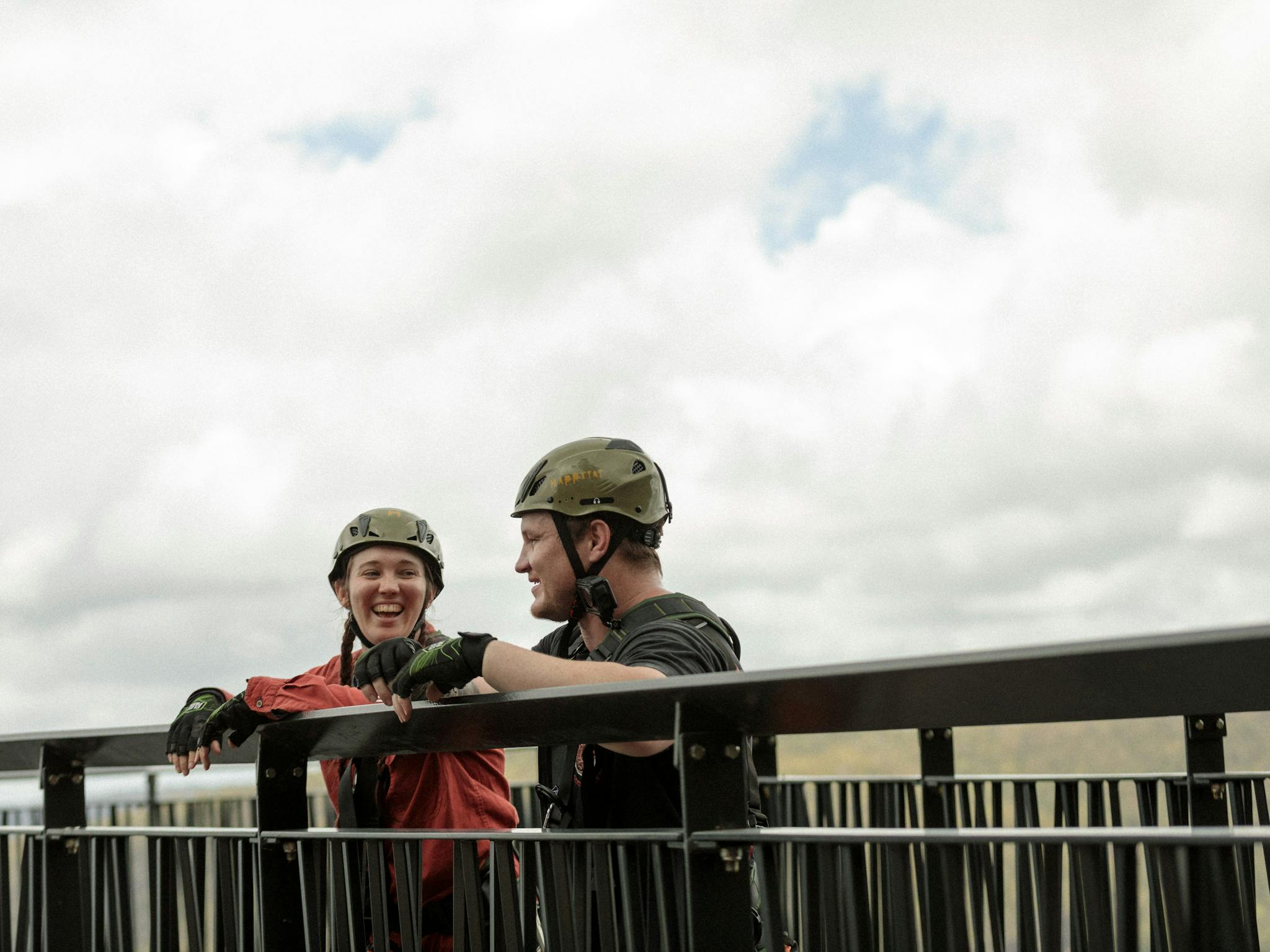 A male and a female adventurer overlooking the zipline tours. A male and a female adventurer overlooking the zipline tours.