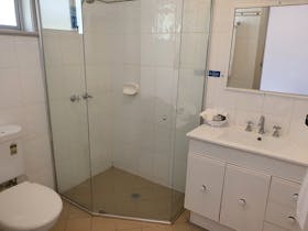Bathroom has a vanity walk in shower and toiletr