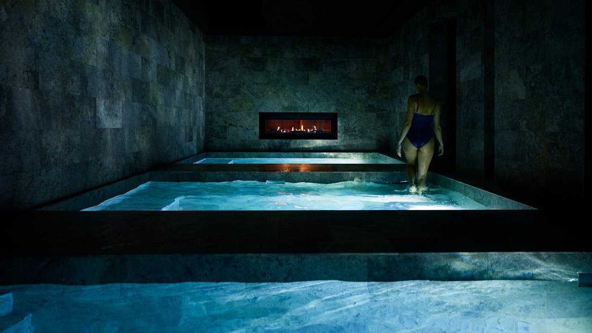 Woman steps out of pool.