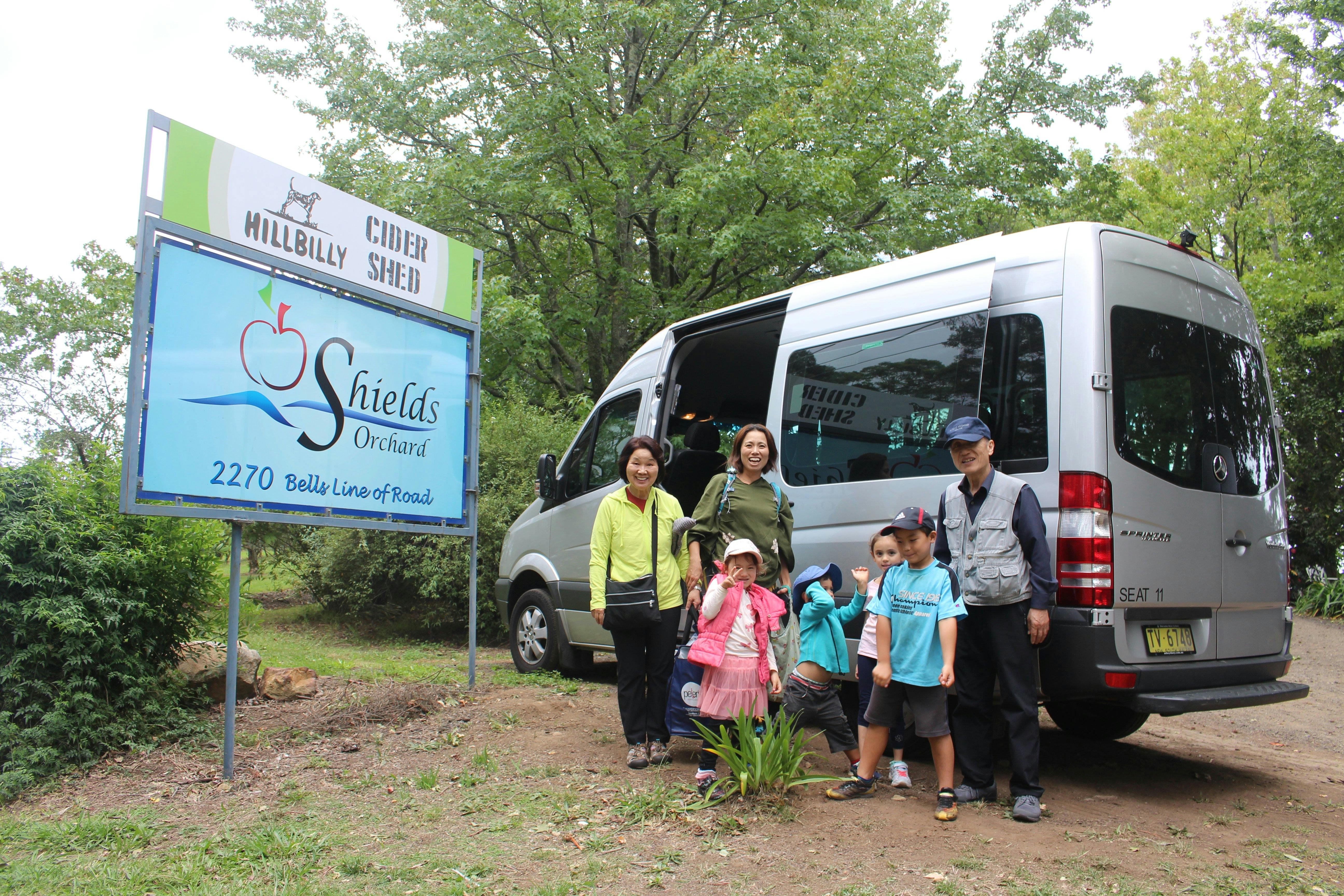 A family group stopping be an orchid and apple cider shop