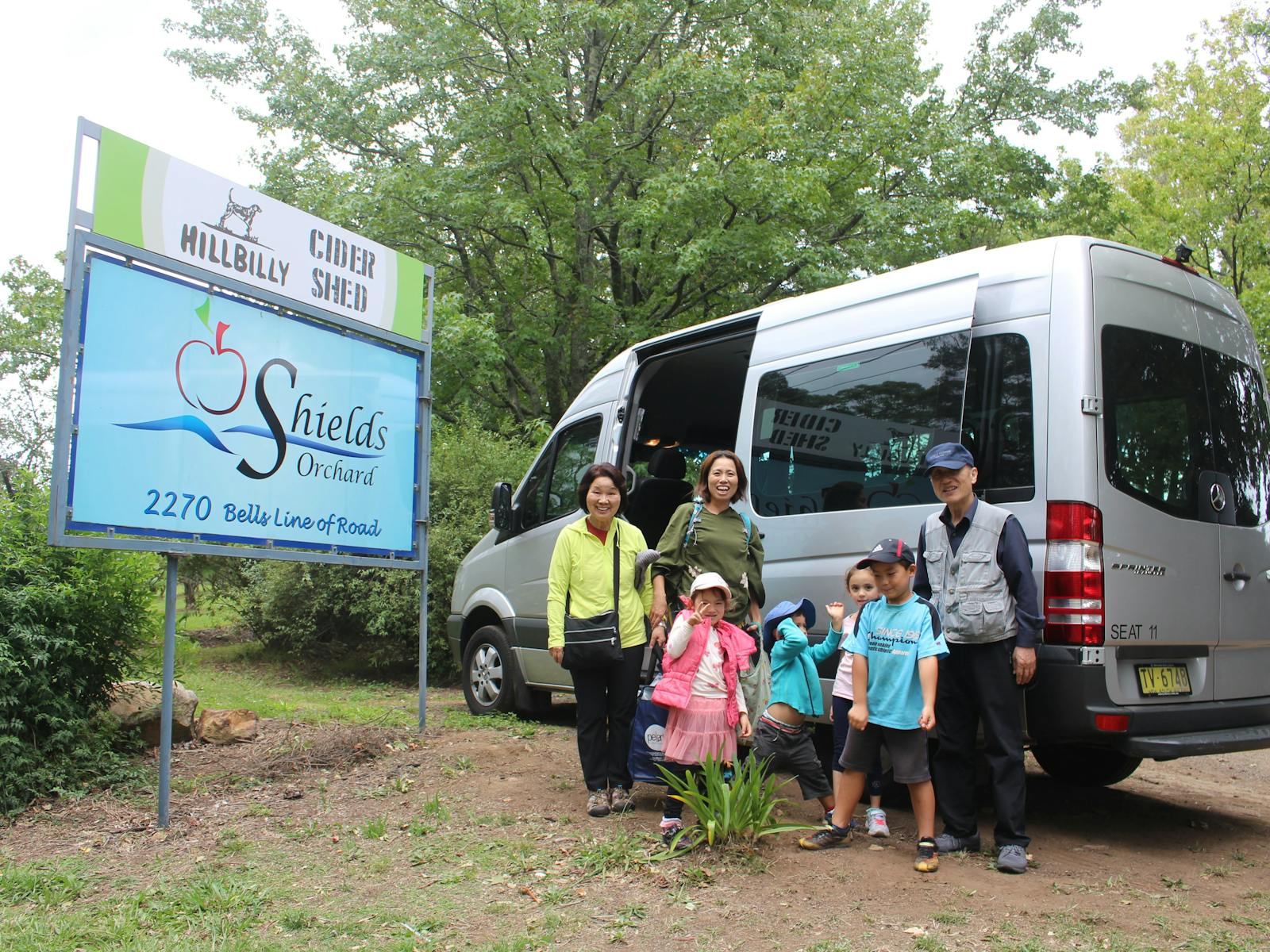 A family group stopping be an orchid and apple cider shop