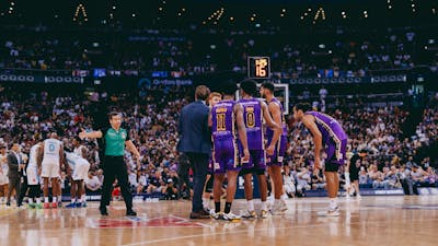 Players gather midcourt during a Sydney Kings game