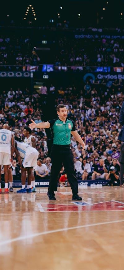 Players gather midcourt during a Sydney Kings game