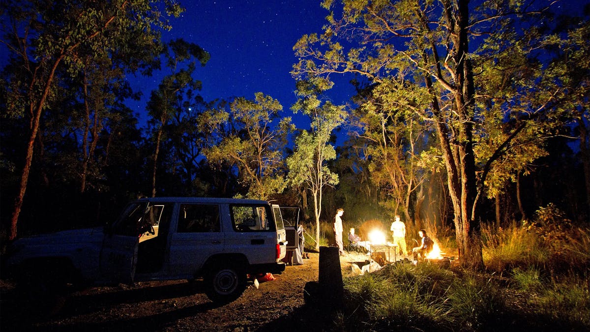 Car and camp light by fire.