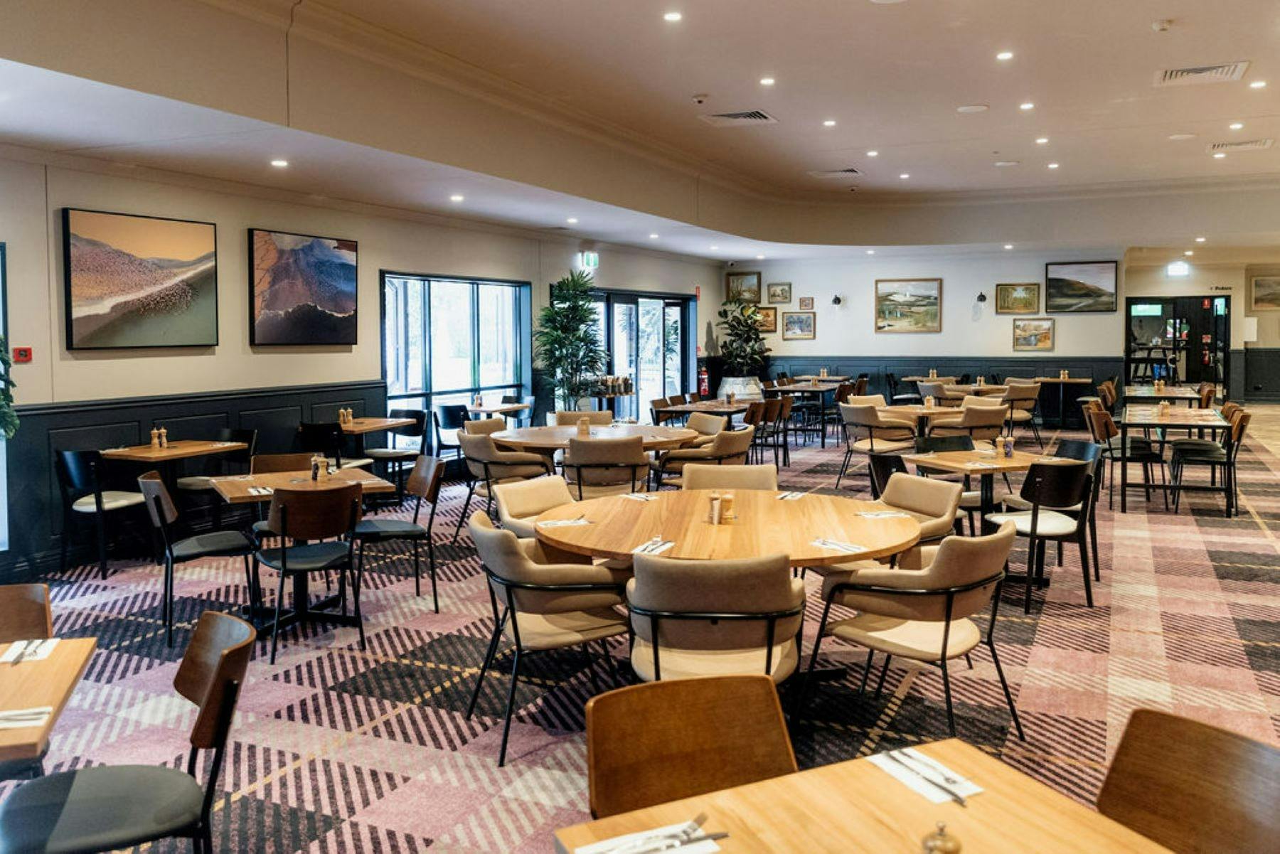 Photo shows the freshly updated bistro with comfortable modern furniture and fresh tartan carpet
