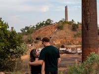 Man and woman looking at Chillagoe’s historic smelter ruins in Queensland’s outback landscape.