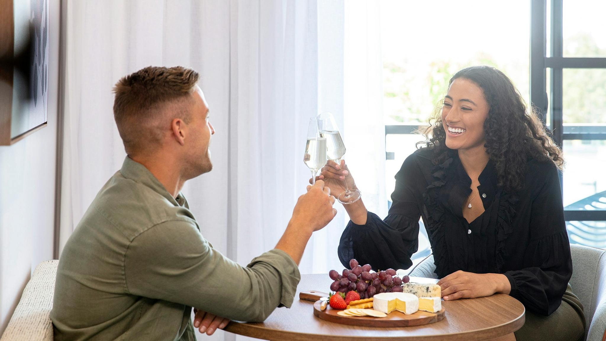 Quest Wangaratta couple cheering with wine and platter