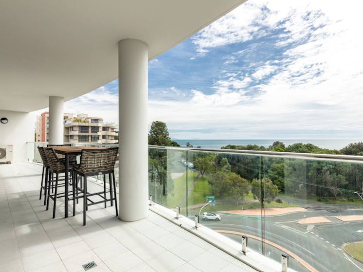 Balcony with outdoor setting and ocean views
