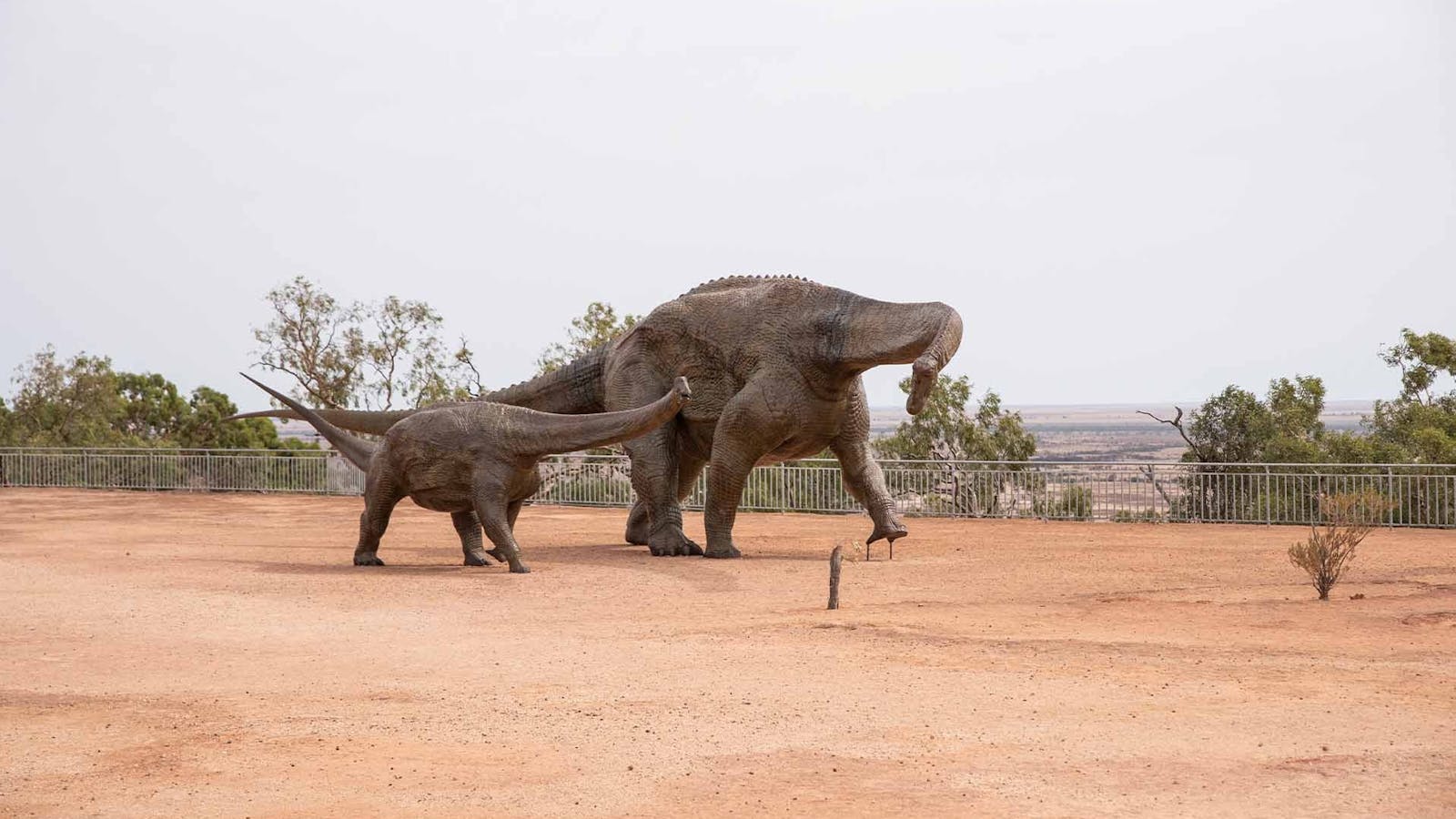 Two dinosaur statues standing next to each other Two dinosaur statues standing next to each other
