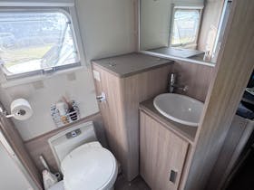 Caravan ensuite including toilet, vanity and washing machine cabinet