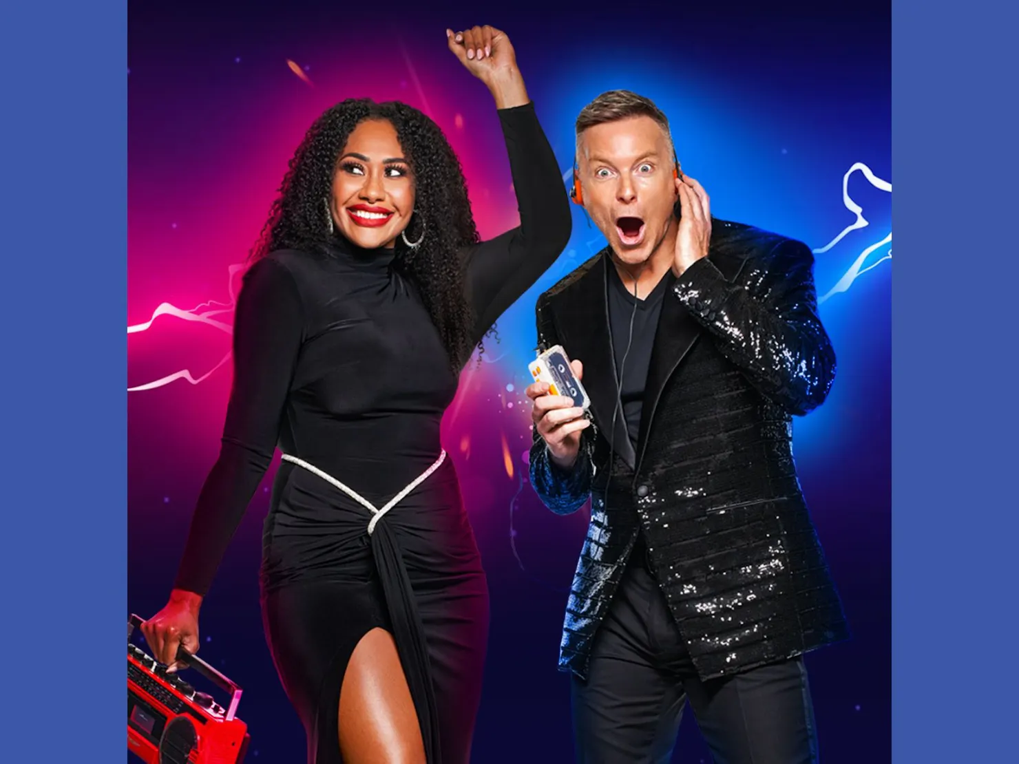 Paulini  left arm in the air in black split dress Tim with 80s earphones on and cassette in hand