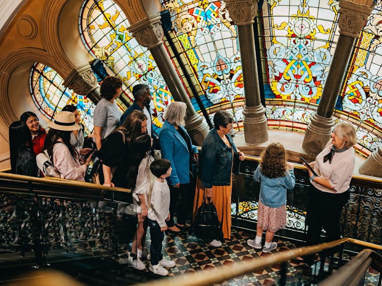 A QVB History Tour group at the stained glass window