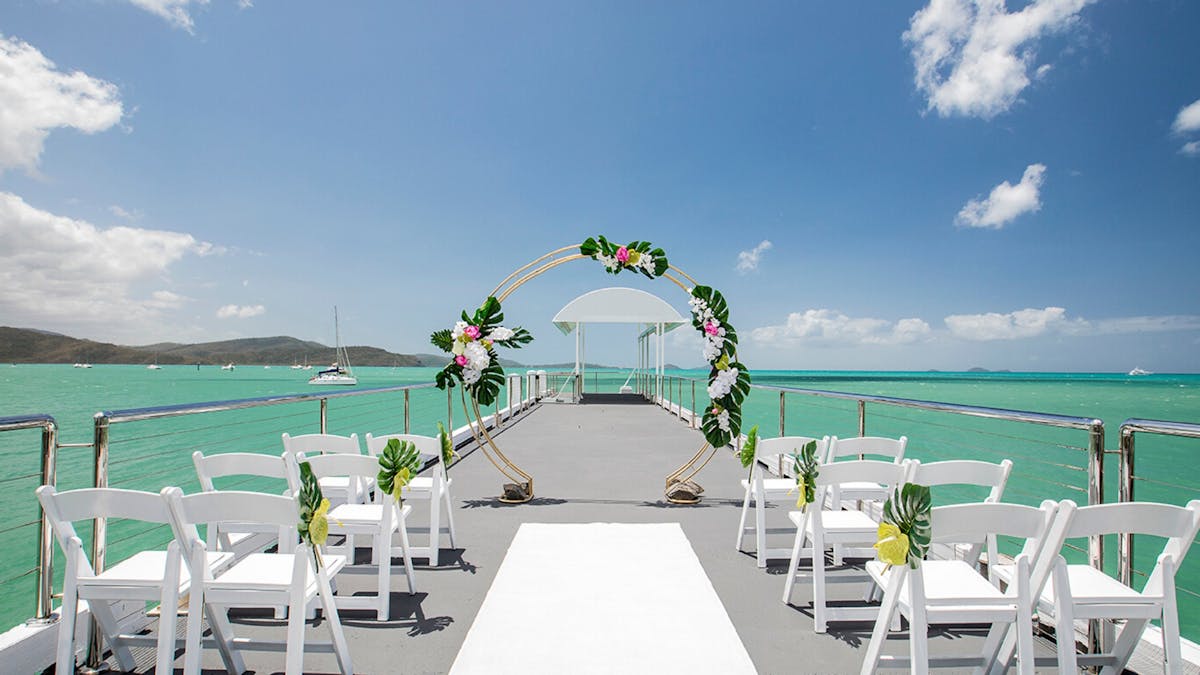 A wedding ceremony set up on The Jetty at Coral Sea Marina Resort