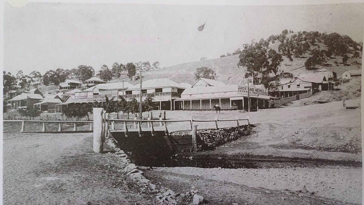 black and white photo of Irvinebank shops and pubs taken from bridge in early 1900s