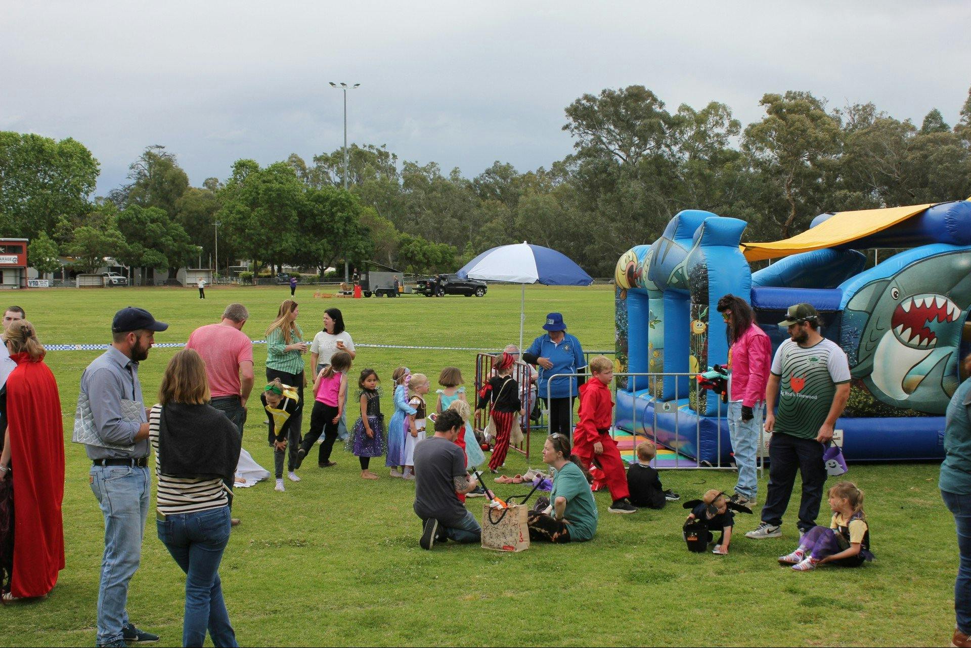 Children in costume lining up for the jumping castle