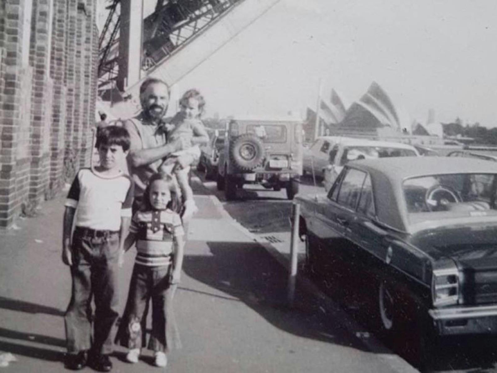 A sepia photograph of a father and his children.