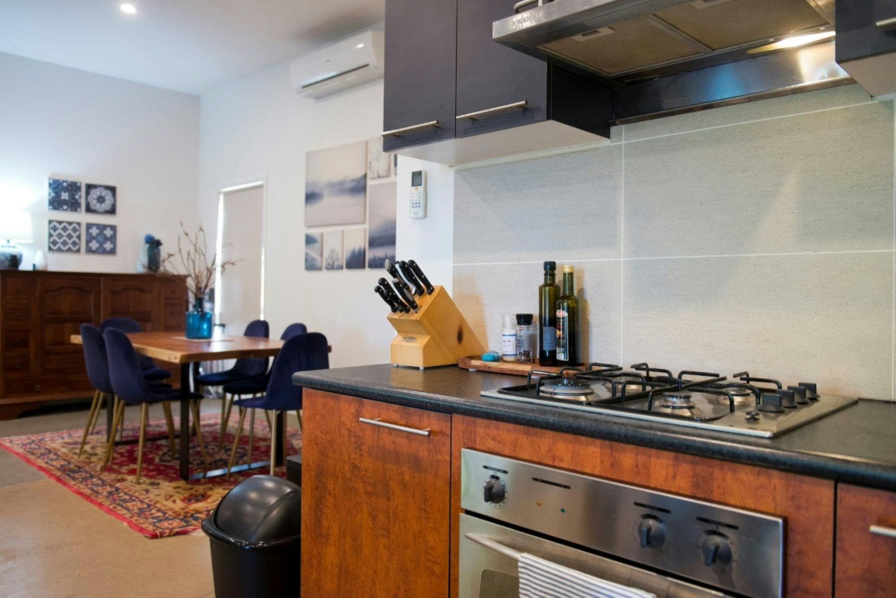 A kitchen with the dining table in the background