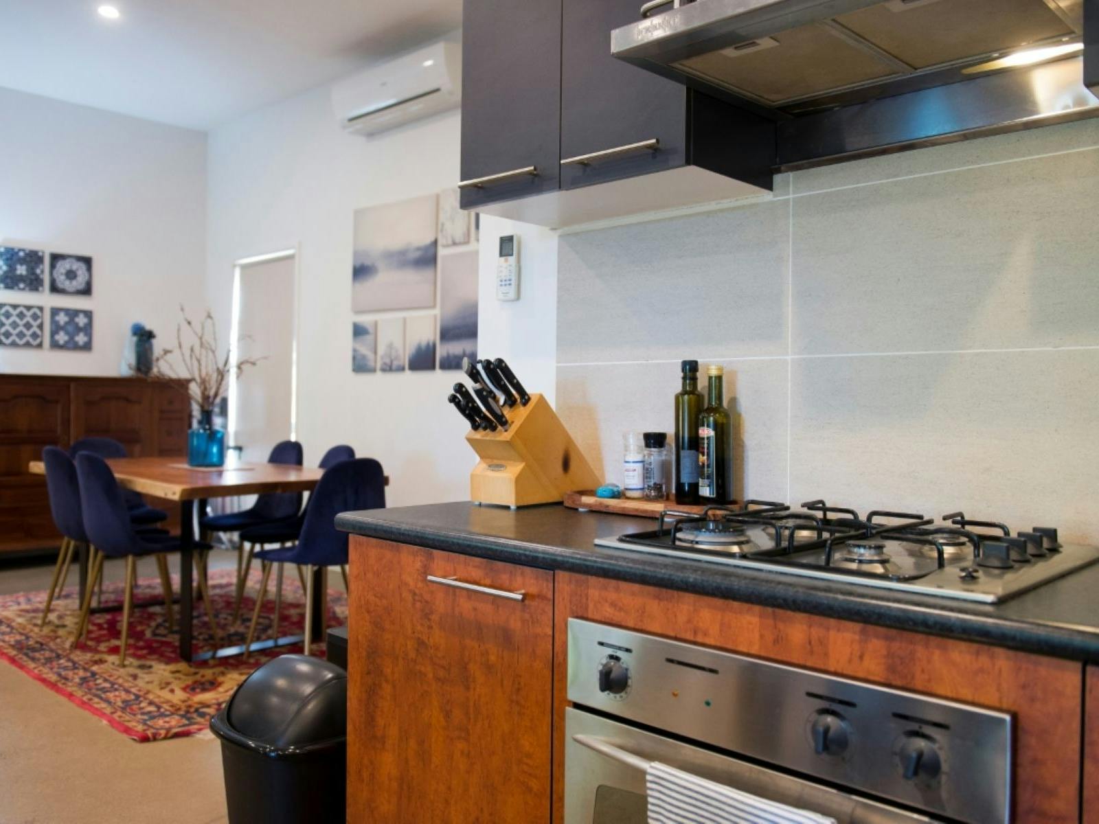 A kitchen with the dining table in the background