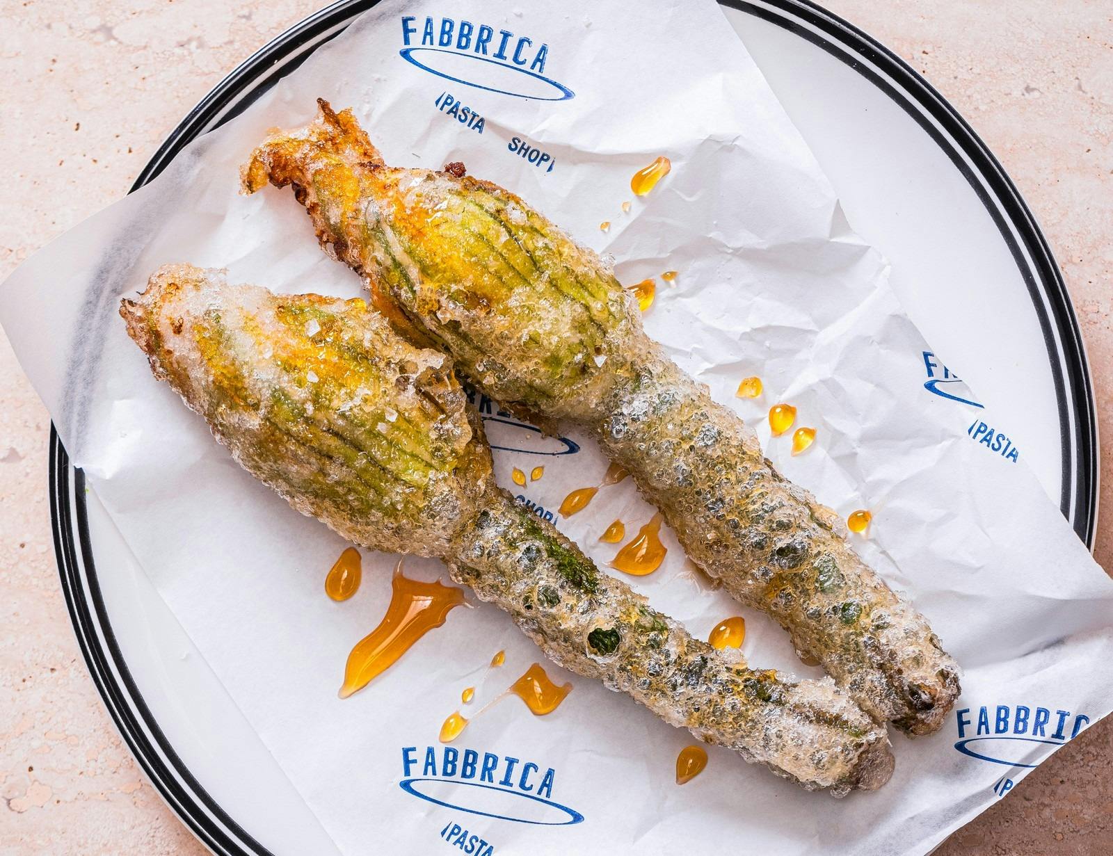 Golden battered zucchini flowers drizzled with honey