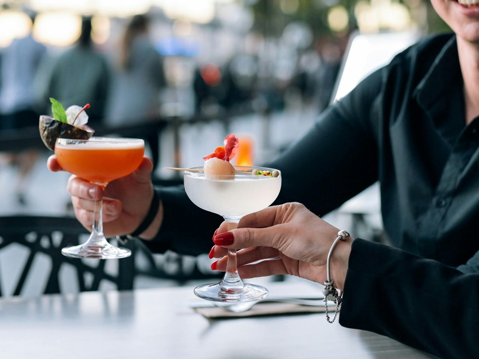 한 라운드의 칵테일을 응원하는 커플은 패션프루트가 든 오렌지와 리치가 든 한 잔