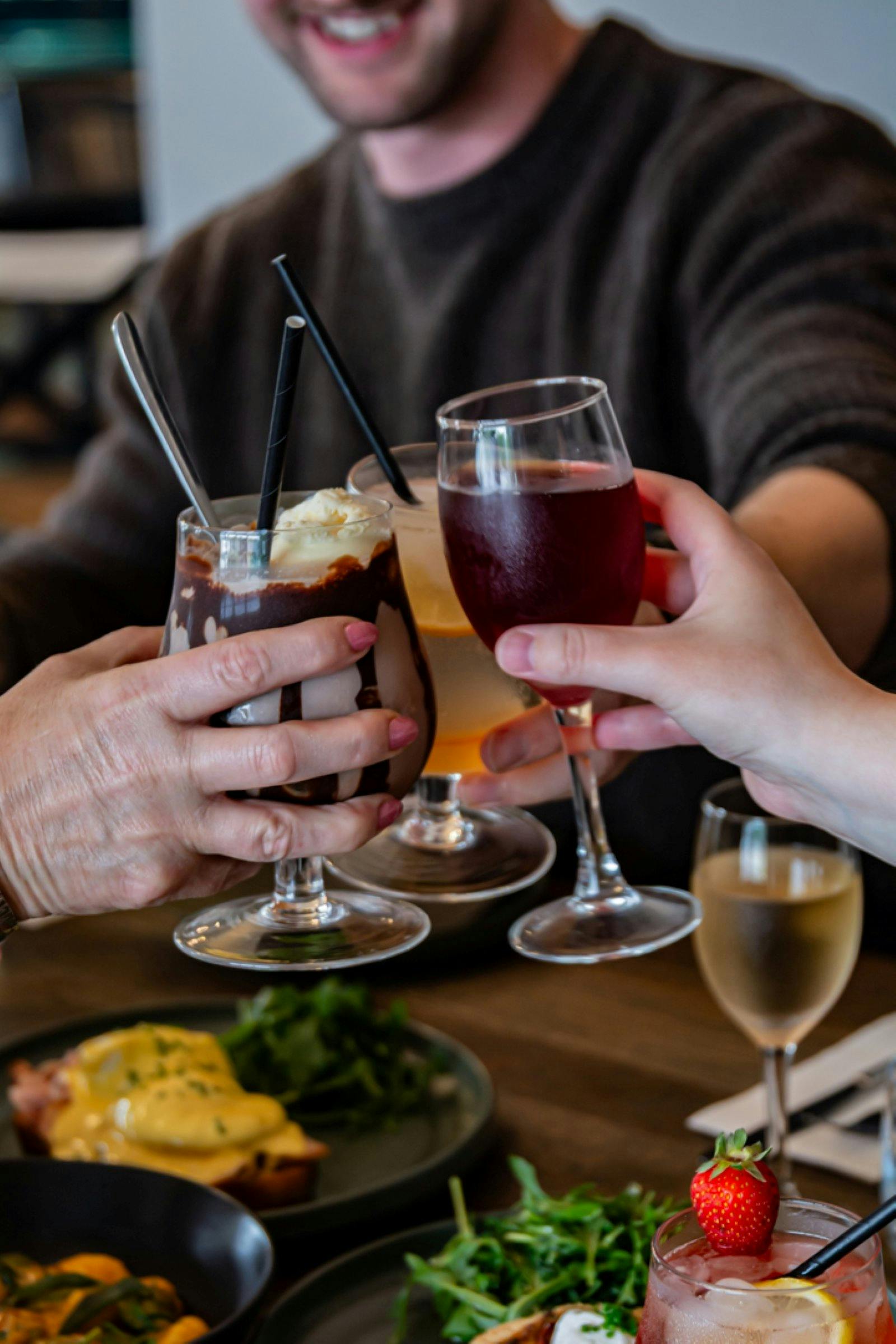 Three drinks are being toasted