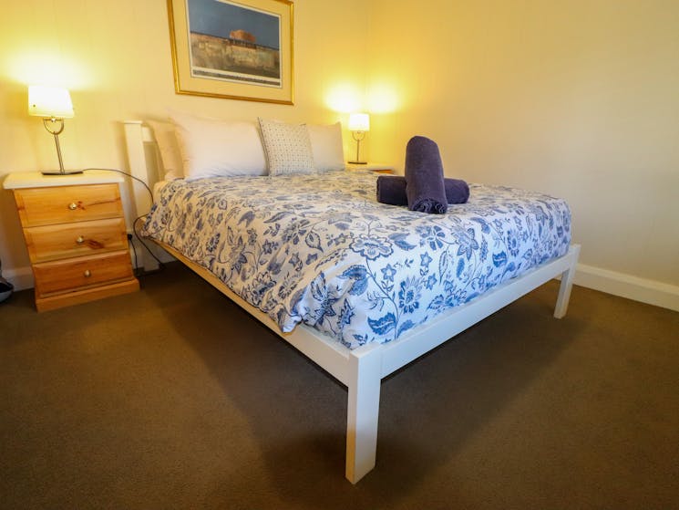 The main bedroom features a queen size bed