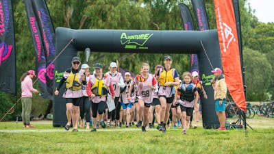 teams are running to their kayaks at the Women Only Adventure Race