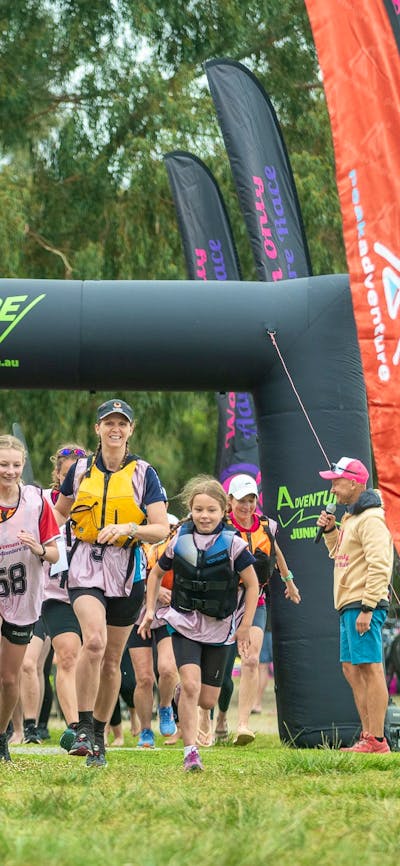 teams are running to their kayaks at the Women Only Adventure Race