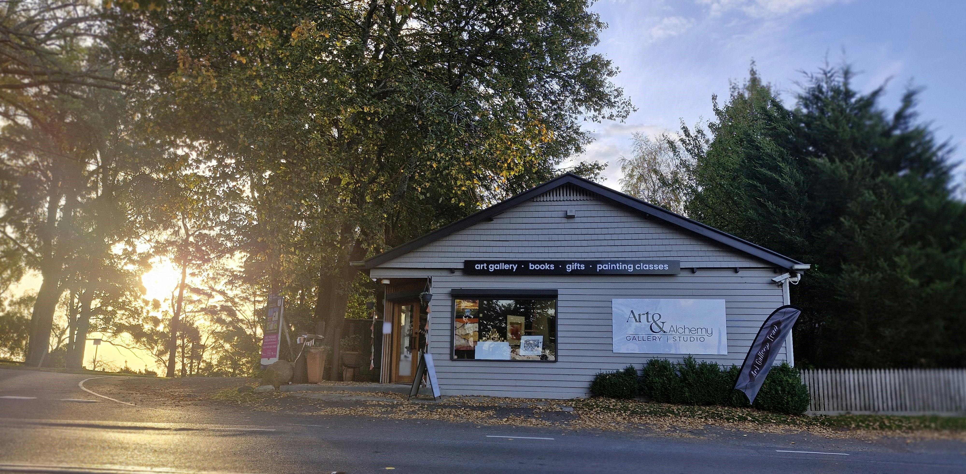 The building of Art & Alchemy Gallery & Studio  from across the road with sun to the left