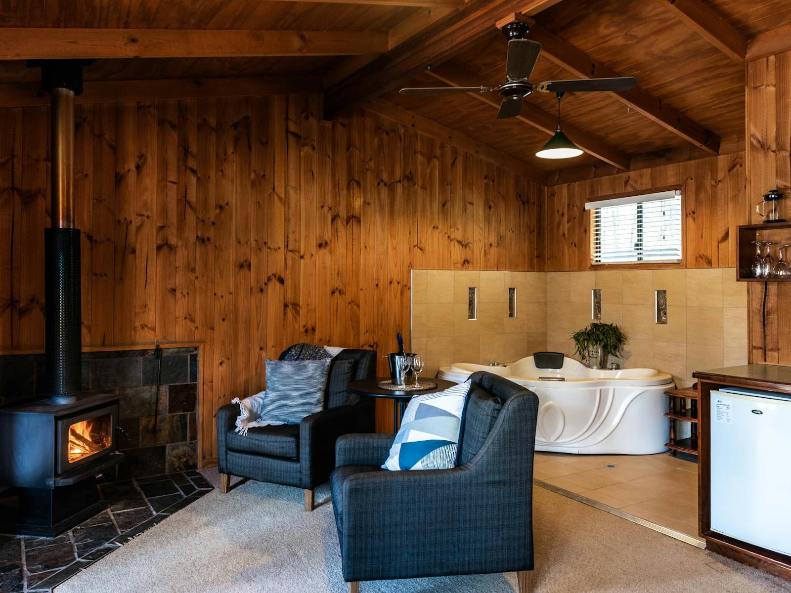 Spacious living area with fire on and spa in the corner Spacious living area with fire on and spa in the corner