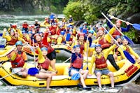 Huge Group photo of all rafting boats waving near Ponytail Falls on the Tully River