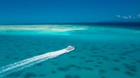 Ocean Freedom 20M stylish Motor Catamaran across turquoise waters on way to Upolu Cay Reef