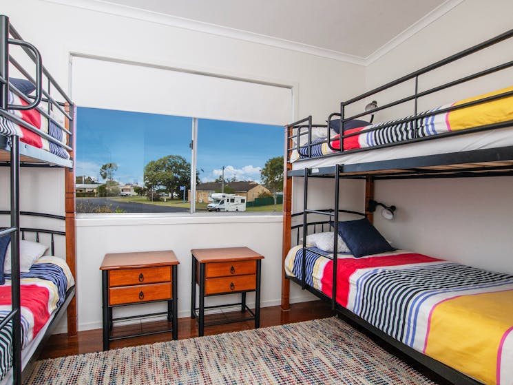 Vibrant Quad Bedroom with Dual Bunk Beds Upstairs.