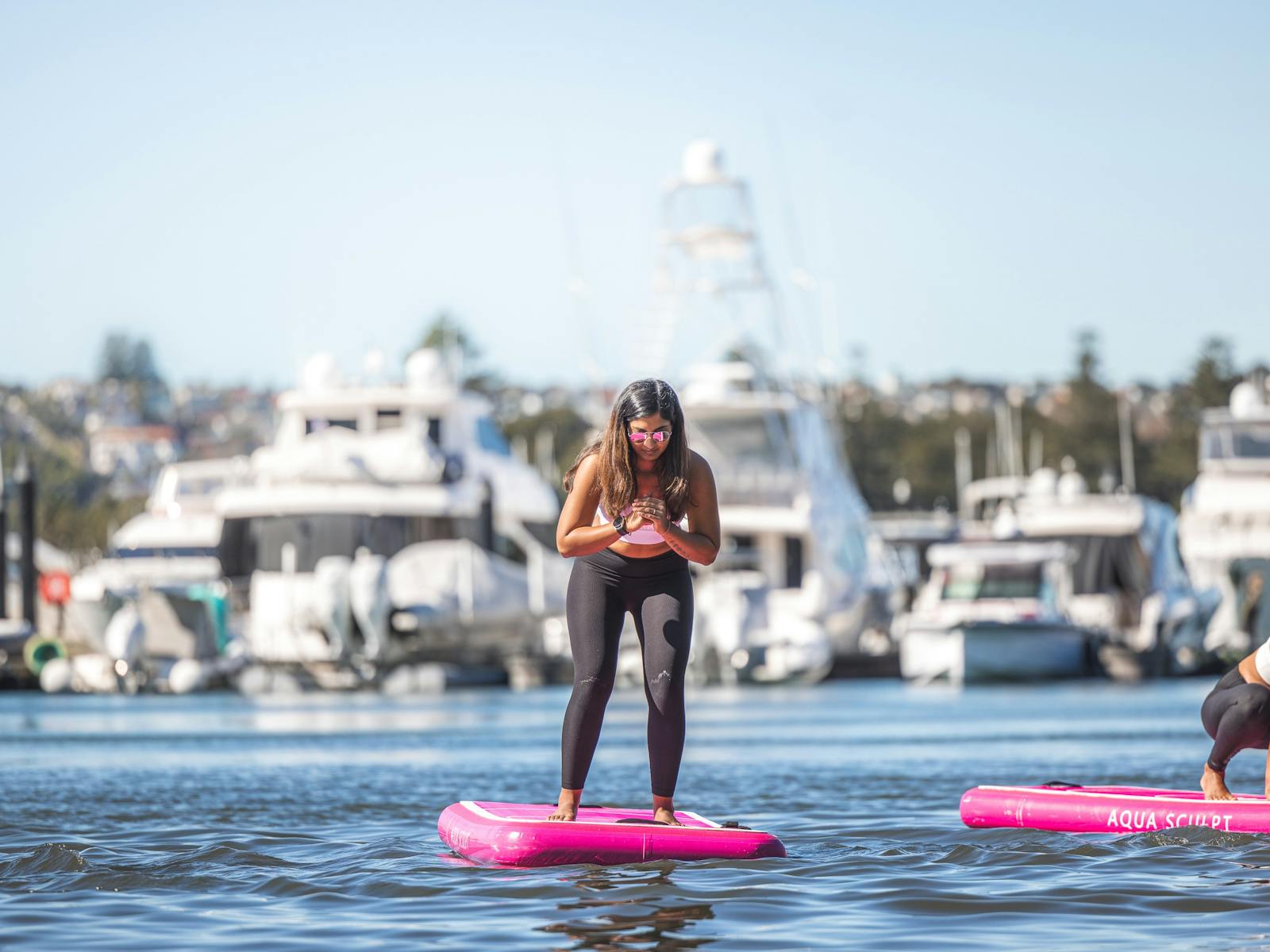 Beginner level participant standing on Aqua Sculpt board
