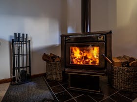 The wood fired combustion heater creates a  wonderful atmosphere and heats the whole home.