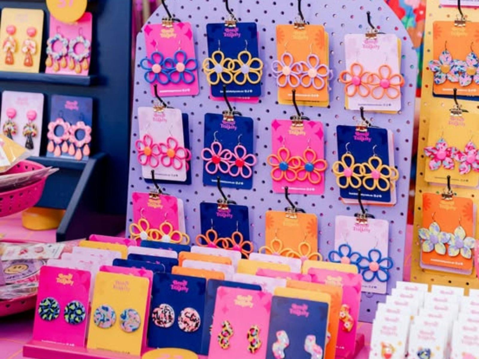 A close up of Colourful polymere clay earrings on a stand