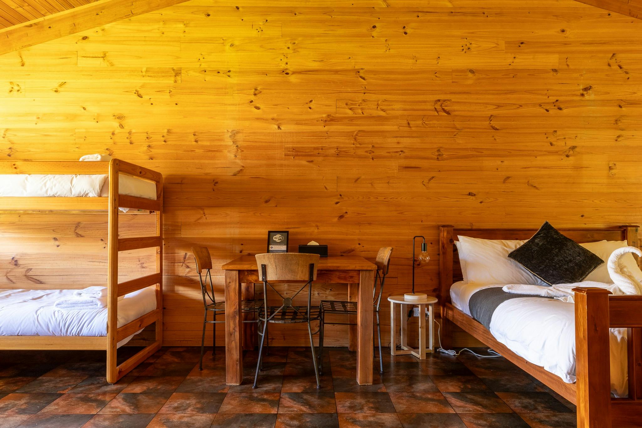 Queen bed, bulks and dinner table.