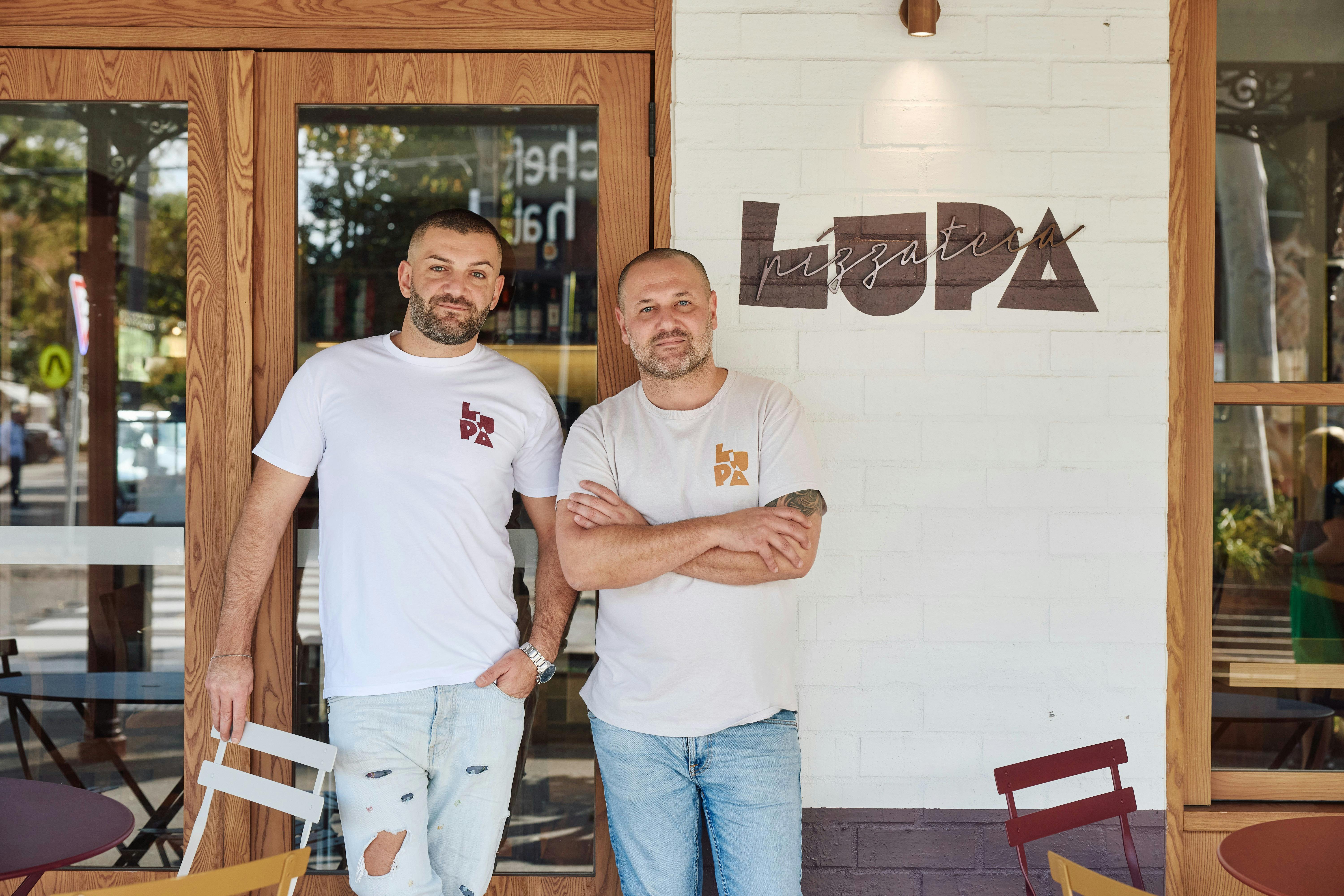 Pizzateca Lupa team standing outside the restaurant beneath the venue sign.