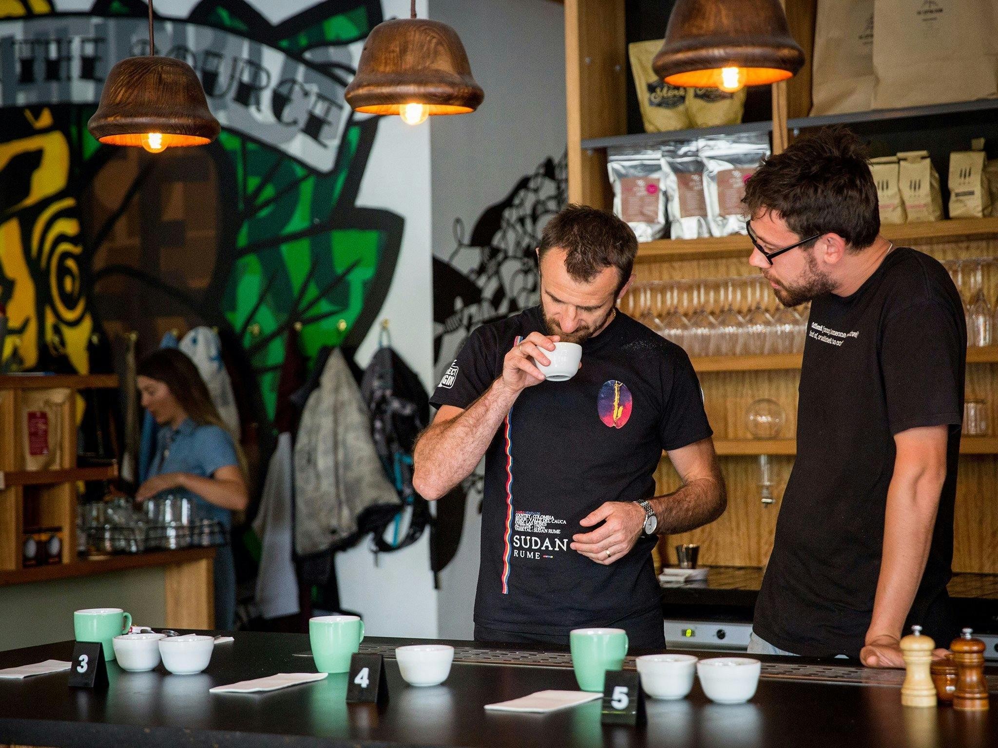Two coffee experts smelling the coffee beans