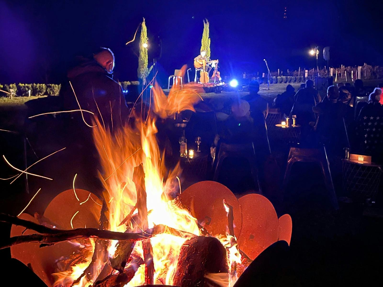 Large firepit with live music in background at Stockmans Ridge Wines