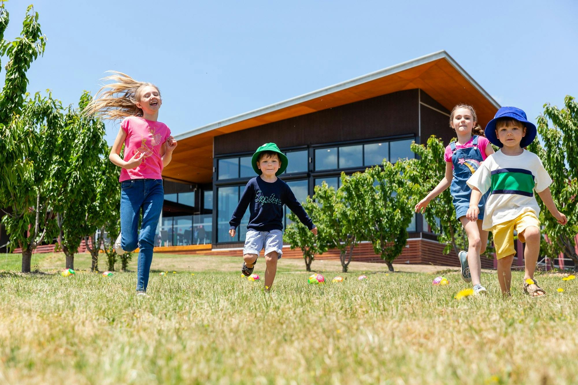 Children running through the orchards
