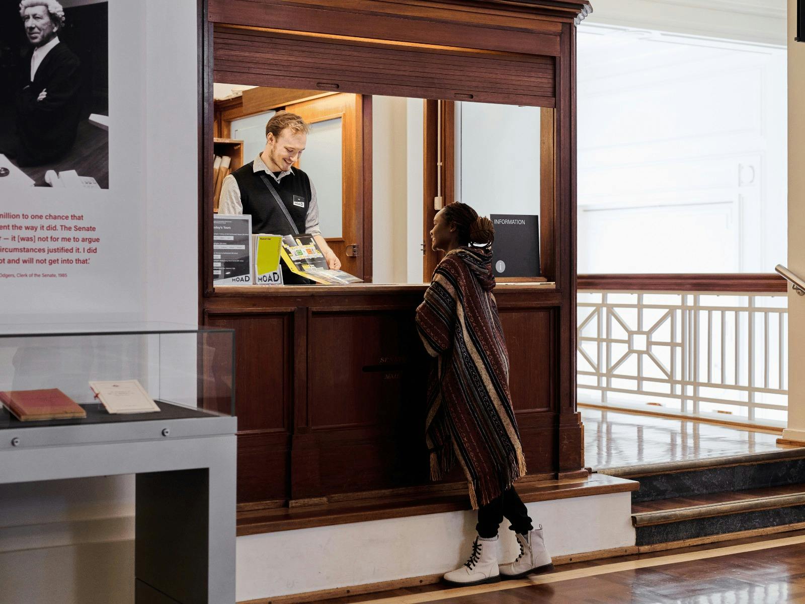 MoAD Experience Officer shows a visitor the museum map
