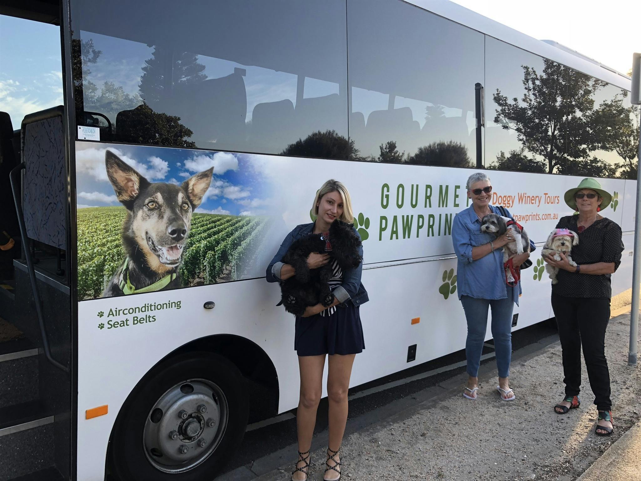 People and dogs next to Bella the bus