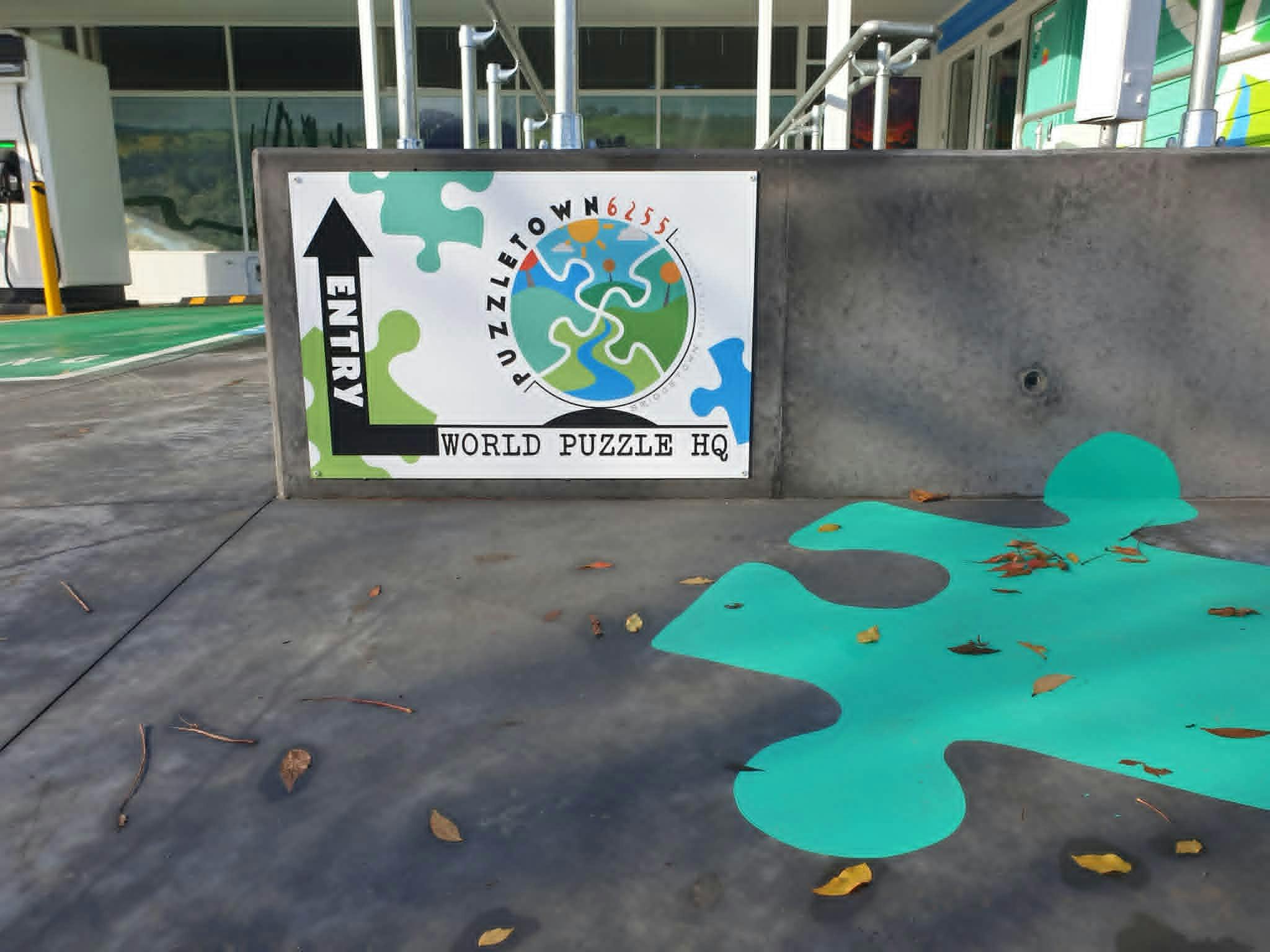 Puzzletown6255 sign to entry with access ramp behind