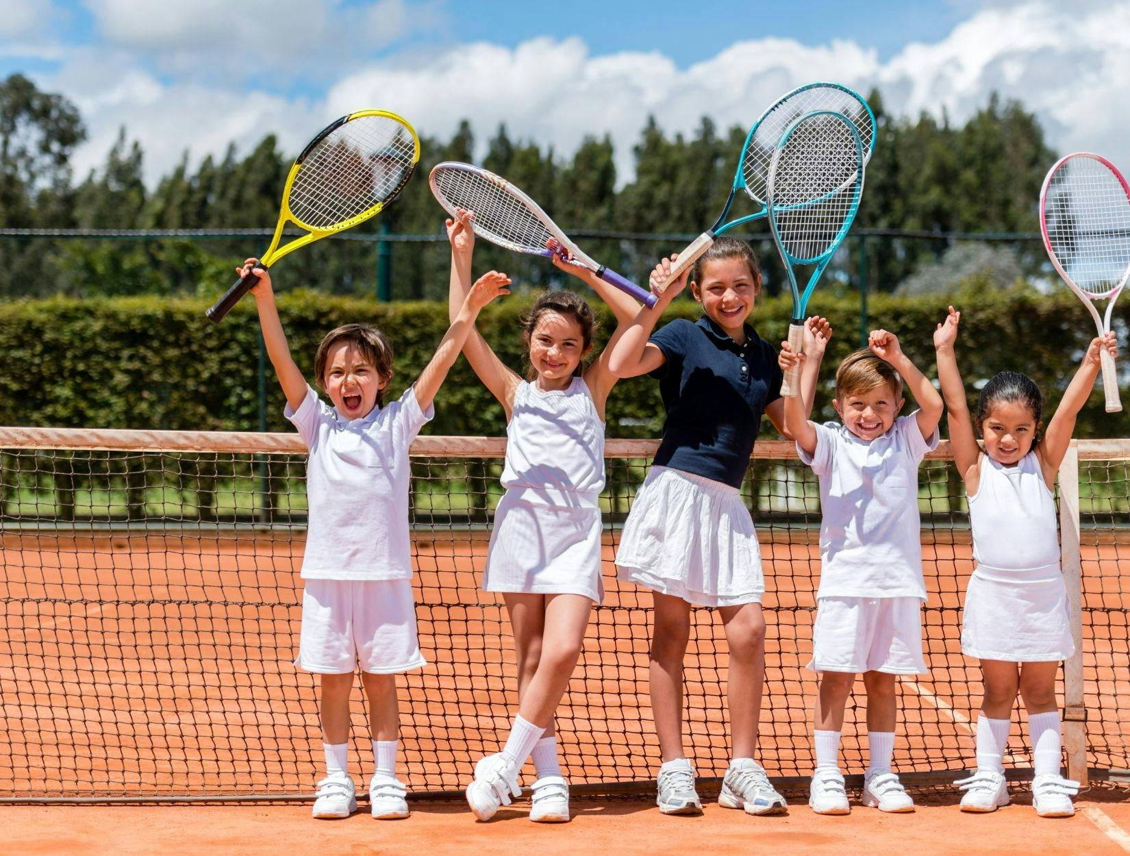 kids posing with their tennis rackets