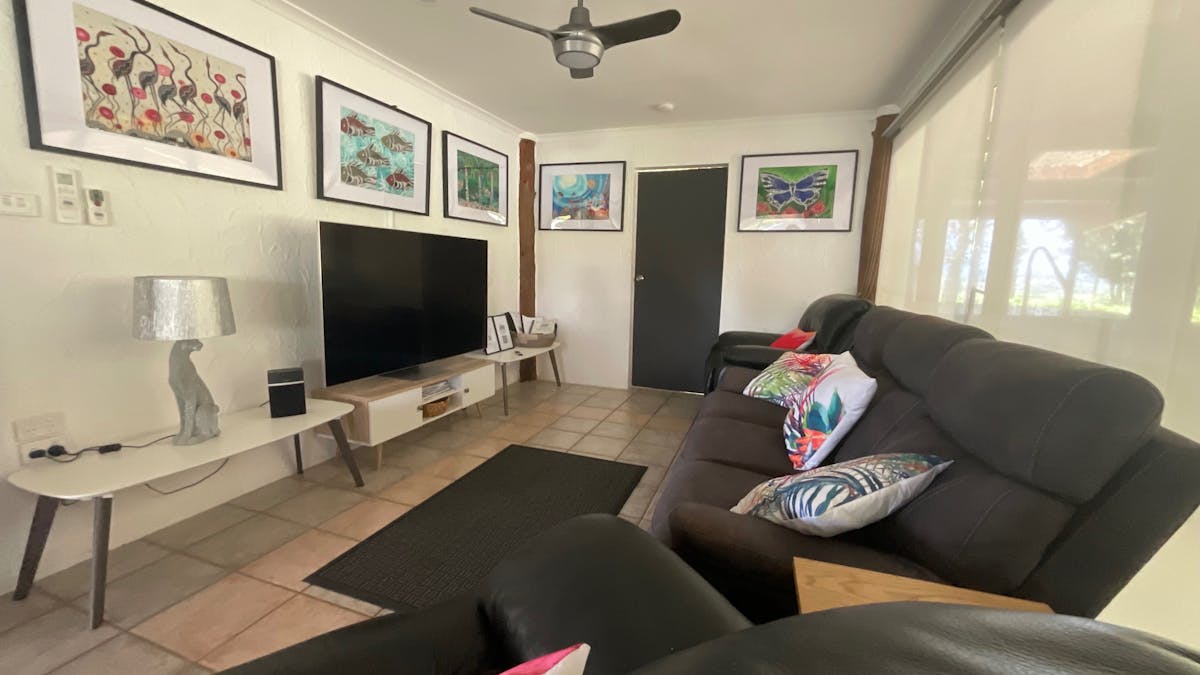 Snug sitting room with comfortable recliners, 65" smart TV all apps downloaded for you to stream