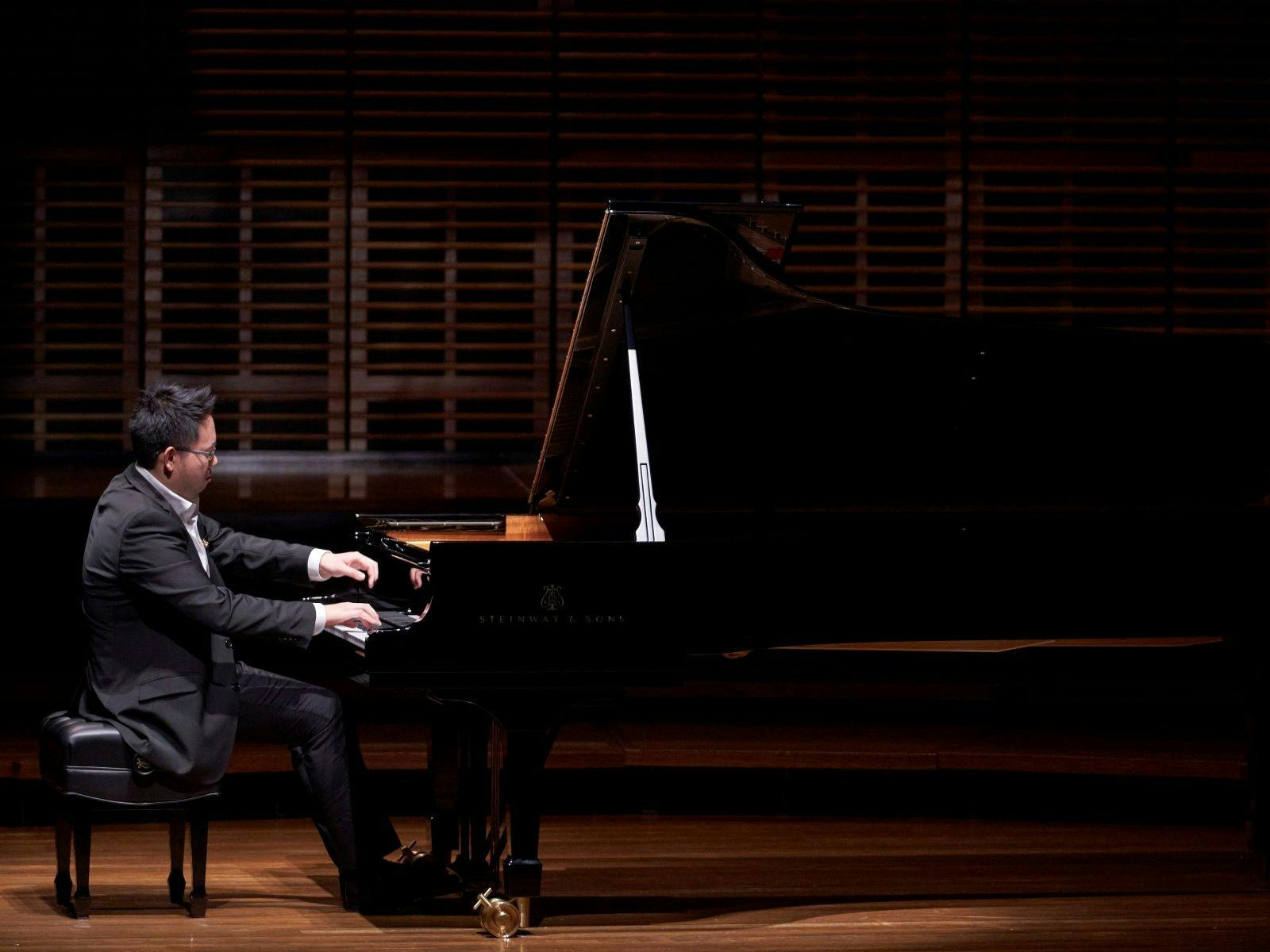 Man playing a grand piano