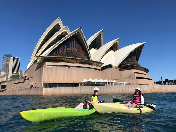 Couple kayaking behind Sydney Opera house