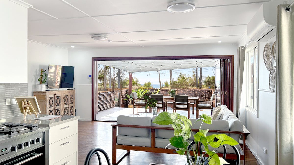 Front Villa (Satu) interior looking out onto large entertaining deck, garden and the ocean.