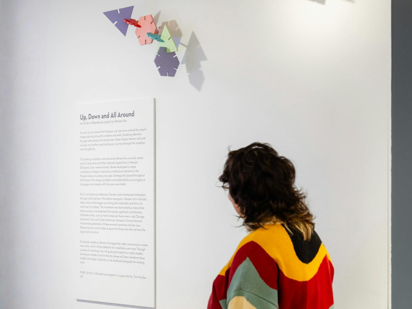 Visitor at Museum of Brisbane looking at the Up, Down and All Around exhibition.